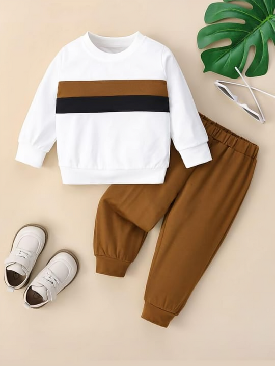 Children's outfit with white and brown top and pants on a beige background